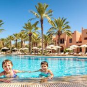 Family enjoying a vibrant poolside oasis at a Moroccan resort