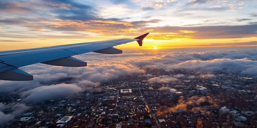 Airplane flying from Manchester to Marrakech at sunset
